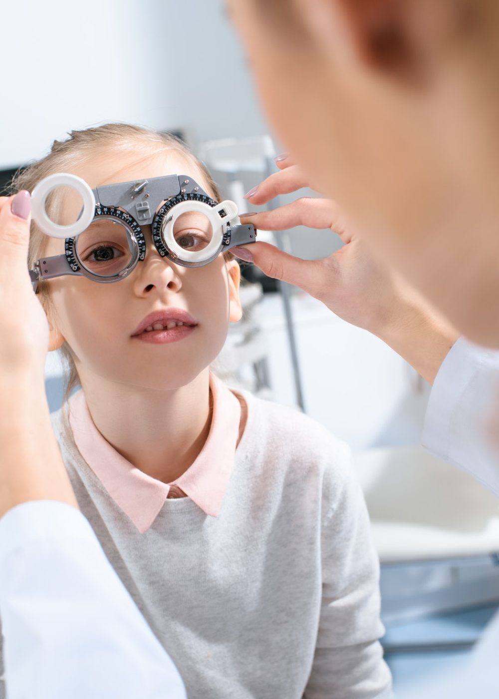 selective-focus-of-ophthalmologist-examining-kid-eyes-with-trial-frame-in-clinic.jpg